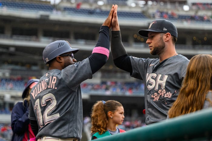 Sep 24, 2023; Washington, District of Columbia, USA; Washington Nationals first base coach Eric Young Jr. (12) and third baseman Carter Kieboom (8) react before the game against the Atlanta Braves at Nationals Park.